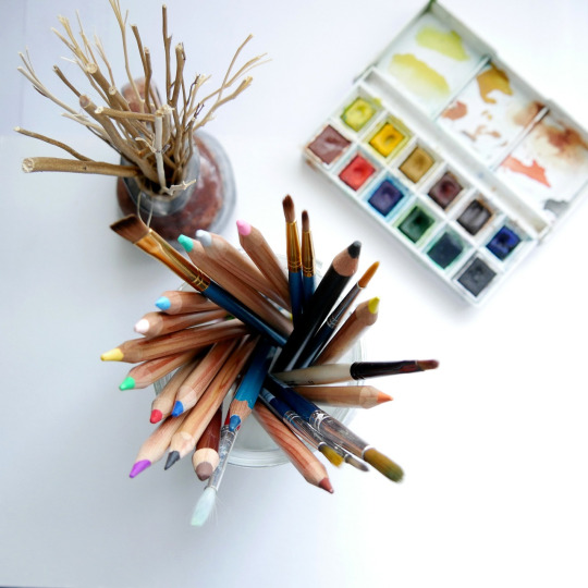 sketchbook with pencils and brushes